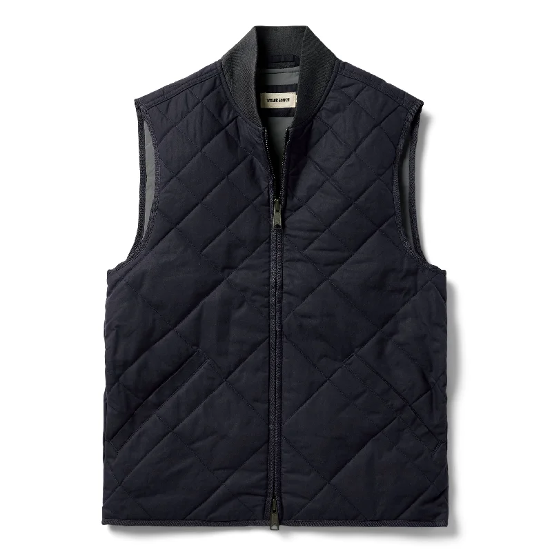 Zip - front men vest with multiple inner pockets for storage The Quilted Bomber Vest in Navy Dry Wax