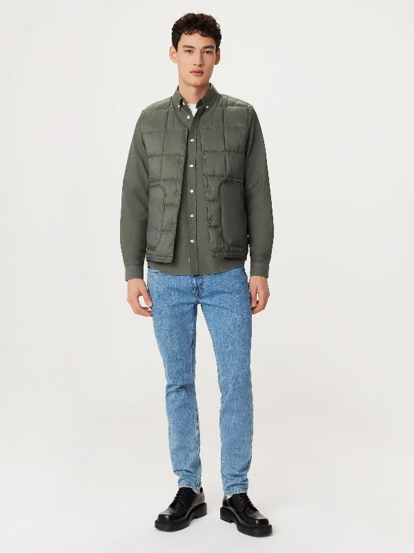 Sleeveless men waistcoats with a high - cut armhole for ease of movement The Aero Quilted Vest in Boreal Green